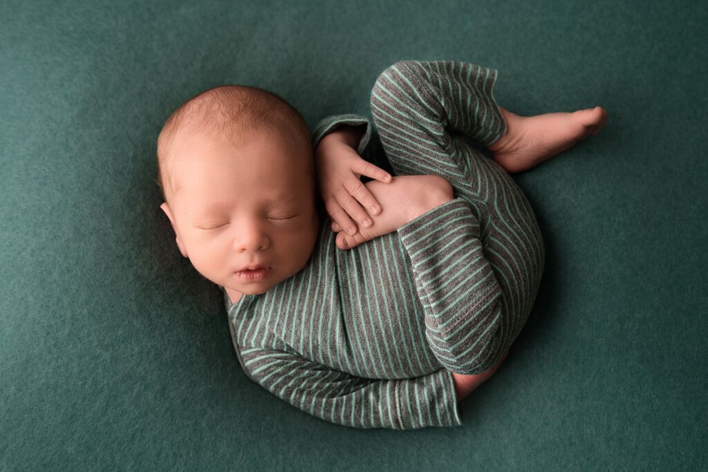 metro detroit newborn photographer newborn boy on teal fabric backdrop