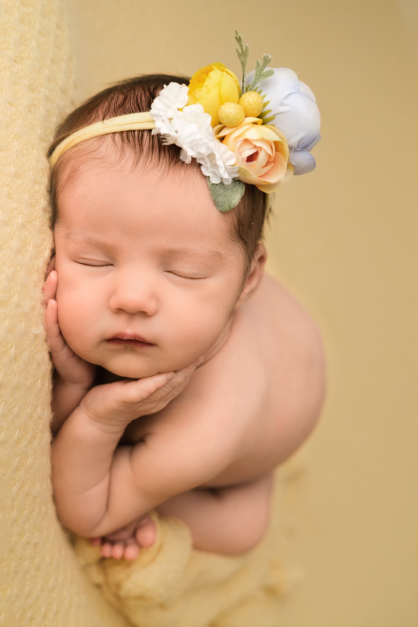 newborn girl on yellow