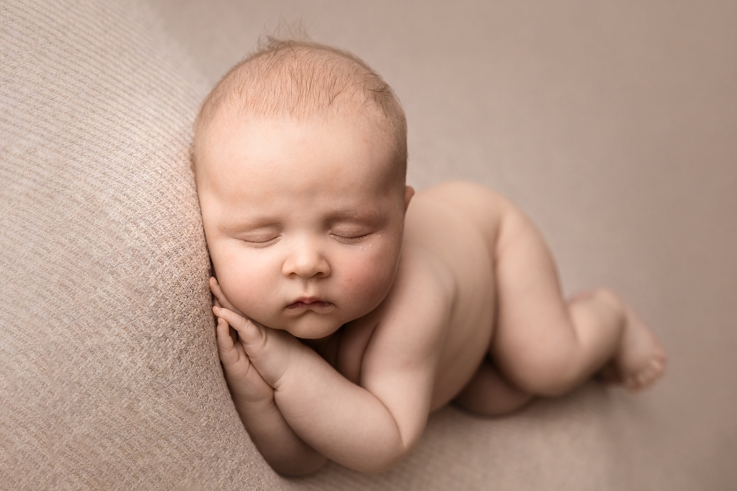 baby boy newborn photograph on neutral color backdrop
