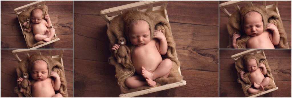 Newborn boy in small bed with bear bonnet and teddy bear