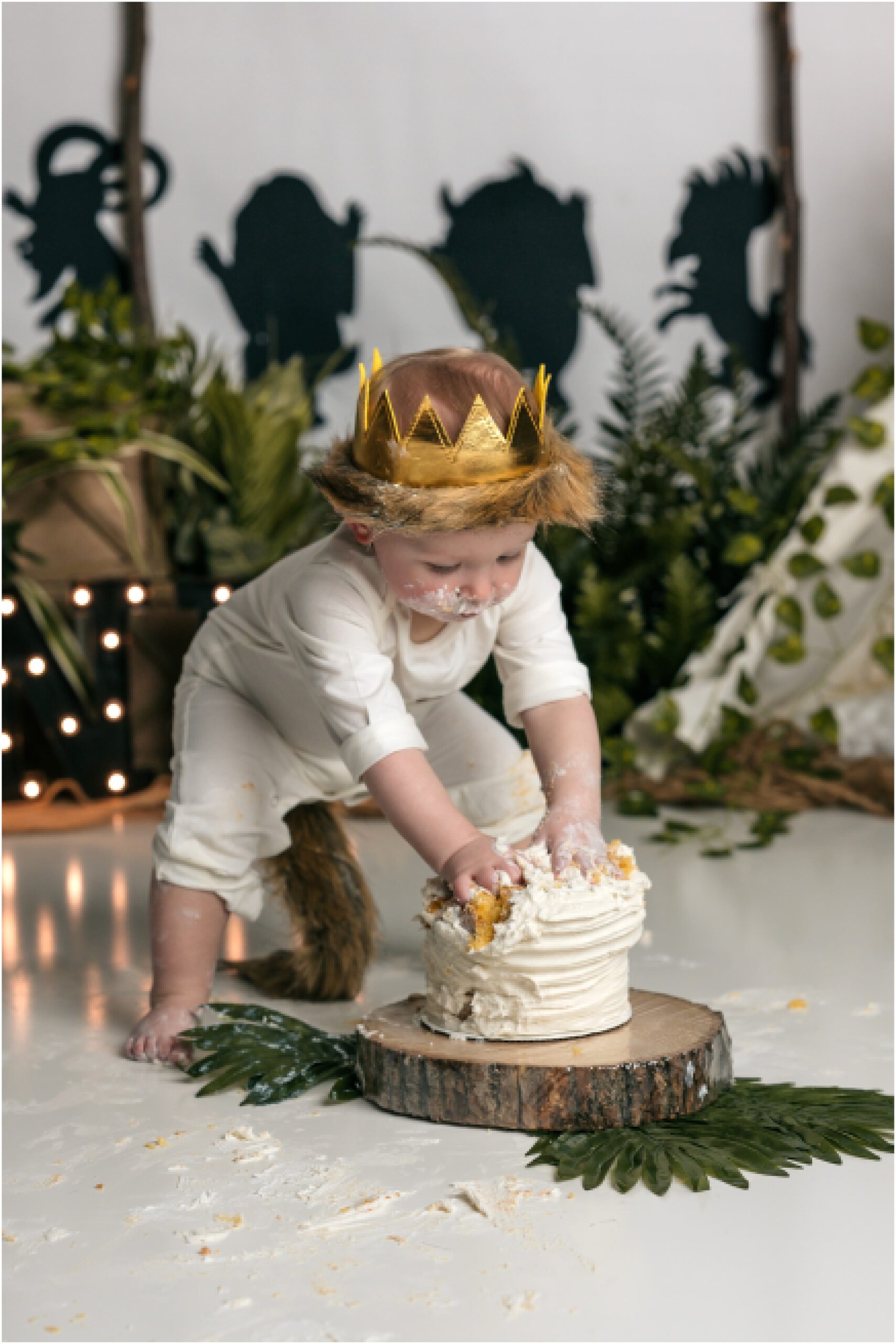 boy standing and smashing a cake