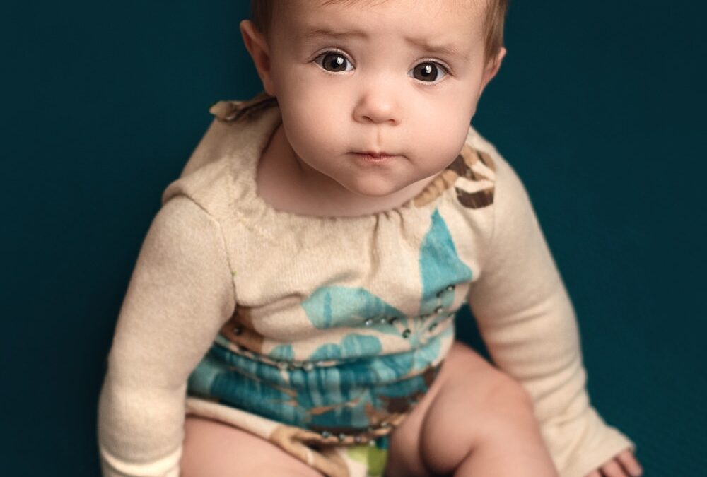 sitter girl in teal and brown romper
