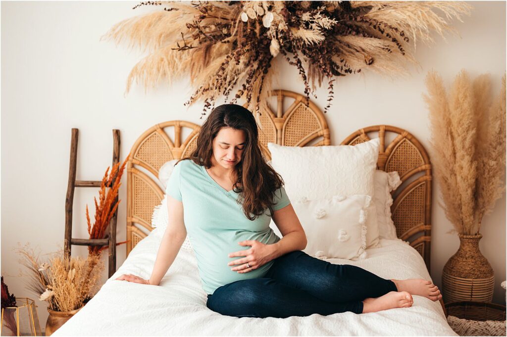 pregnant mom sitting on bed