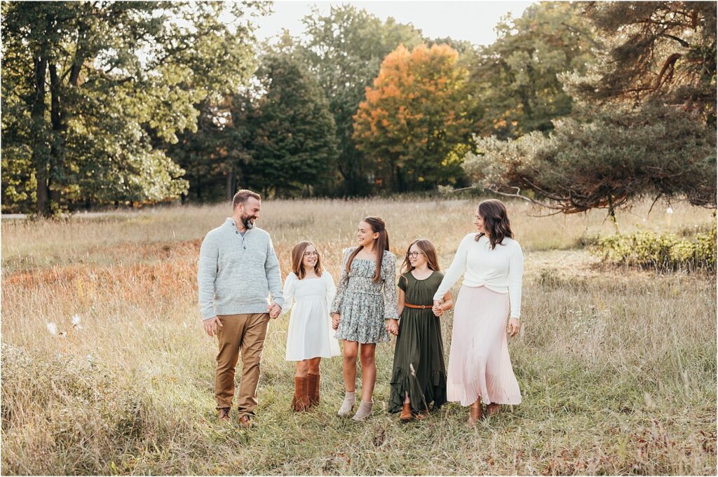 family walking in a field 